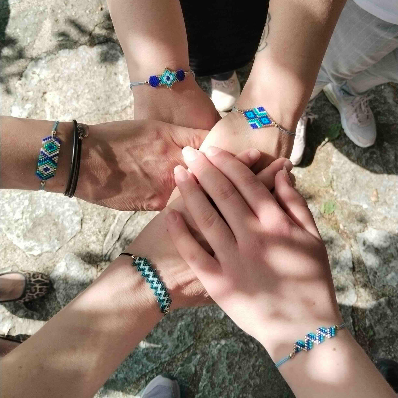 A group of volunteers wearing Take Action Ioannina t-shirts gather outside a cafe